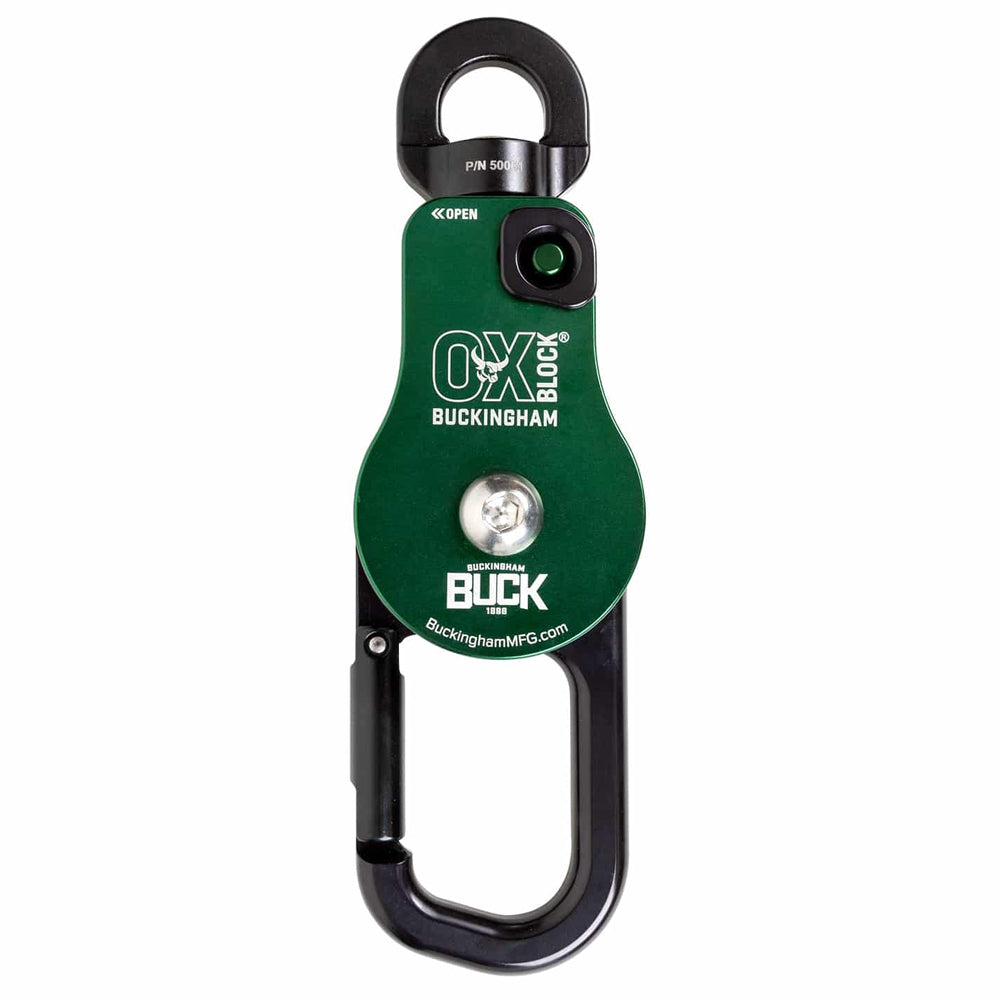A green and black Buckingham OX Block climbing harness anchor device with a carabiner, shown on a plain white background.
