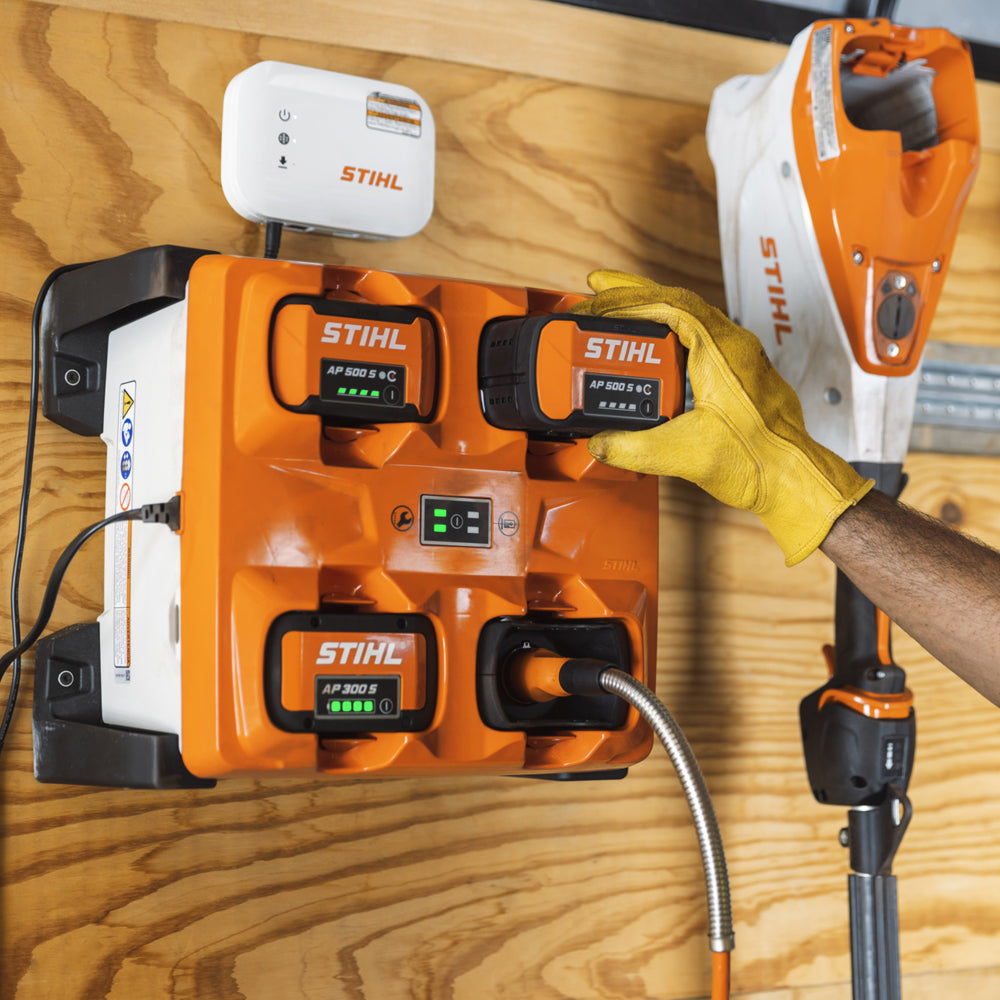 AL 301-4 Multi-Battery Charger in use with tools. A practical charging solution for keeping AP System batteries ready to go. Charge up to 4 STIHL AP System batteries at once. Shop online or in-store at Cannings. 